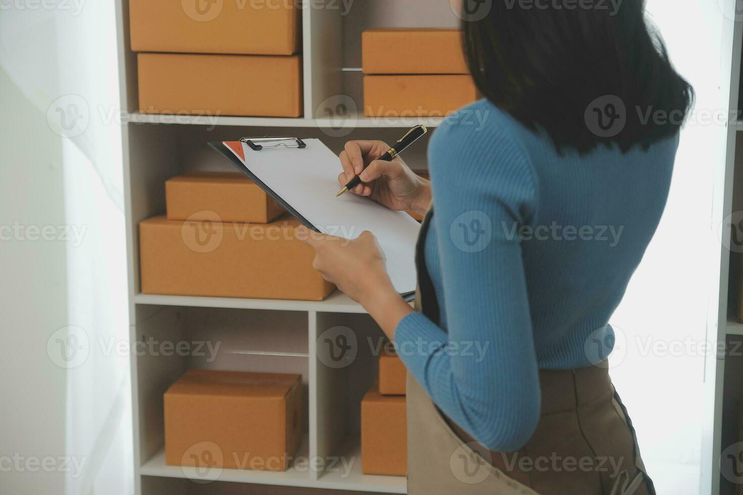 Business woman start up small business entrepreneur SME success .freelance woman working at home with Online Parcel delivery. SME and packaging deliveryconcept photo