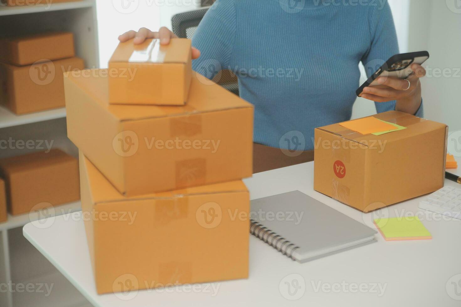 Business woman start up small business entrepreneur SME success .freelance woman working at home with Online Parcel delivery. SME and packaging deliveryconcept photo