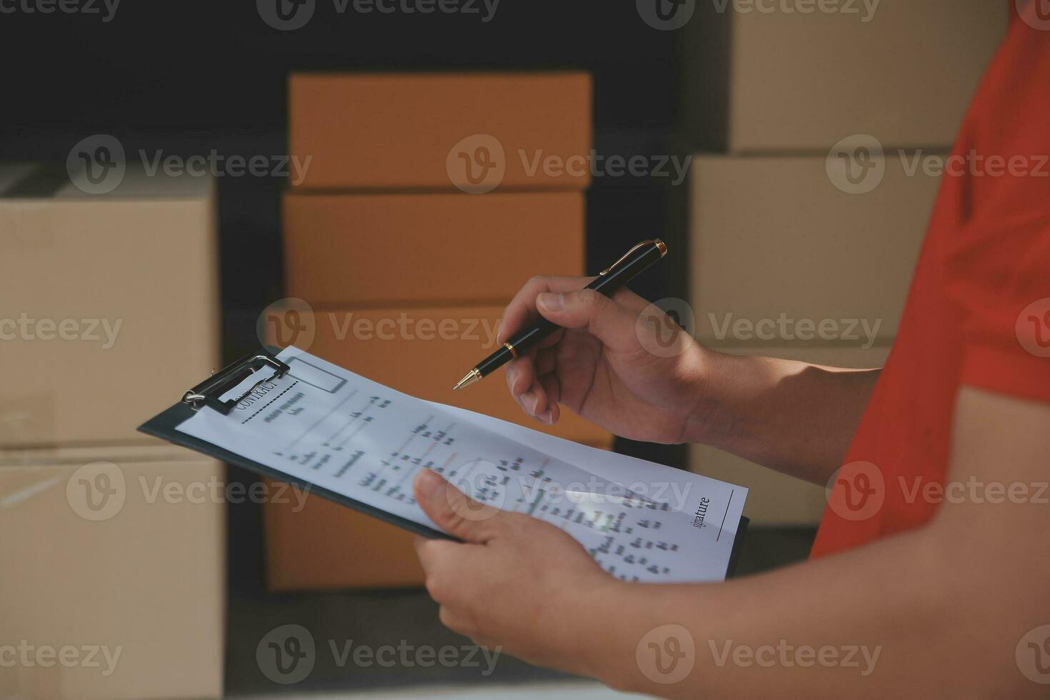 Asian Woman Receiving Product from delivery man at Home, Young Owner Woman Order Product from Smartphone Application, Woman with Online Business or SME Concept. photo
