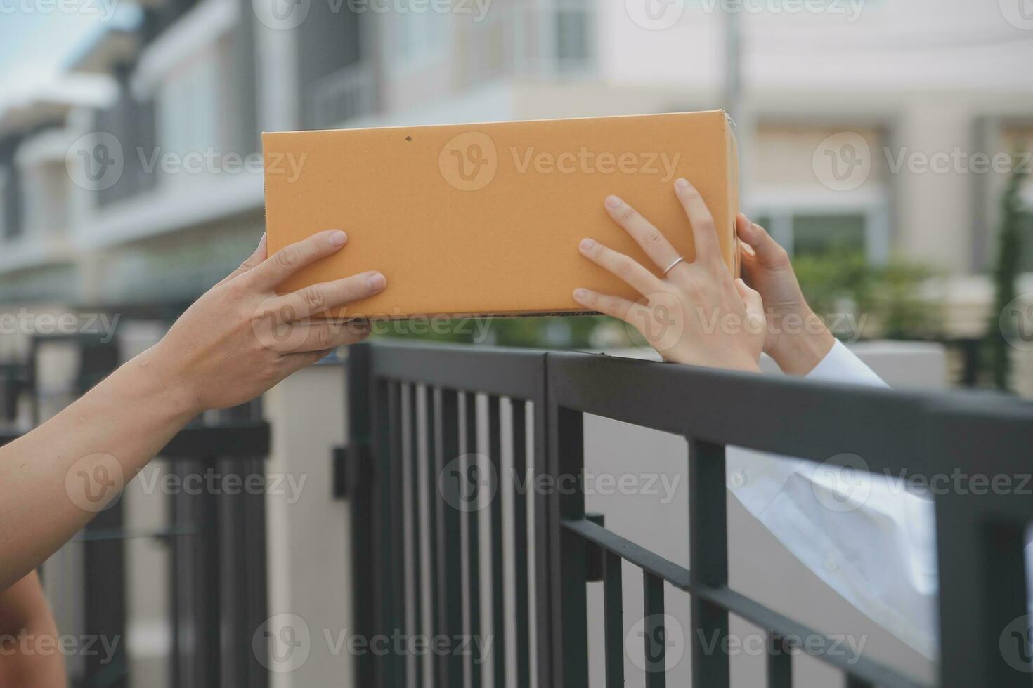 Asian Woman Receiving Product from delivery man at Home, Young Owner Woman Order Product from Smartphone Application, Woman with Online Business or SME Concept. photo