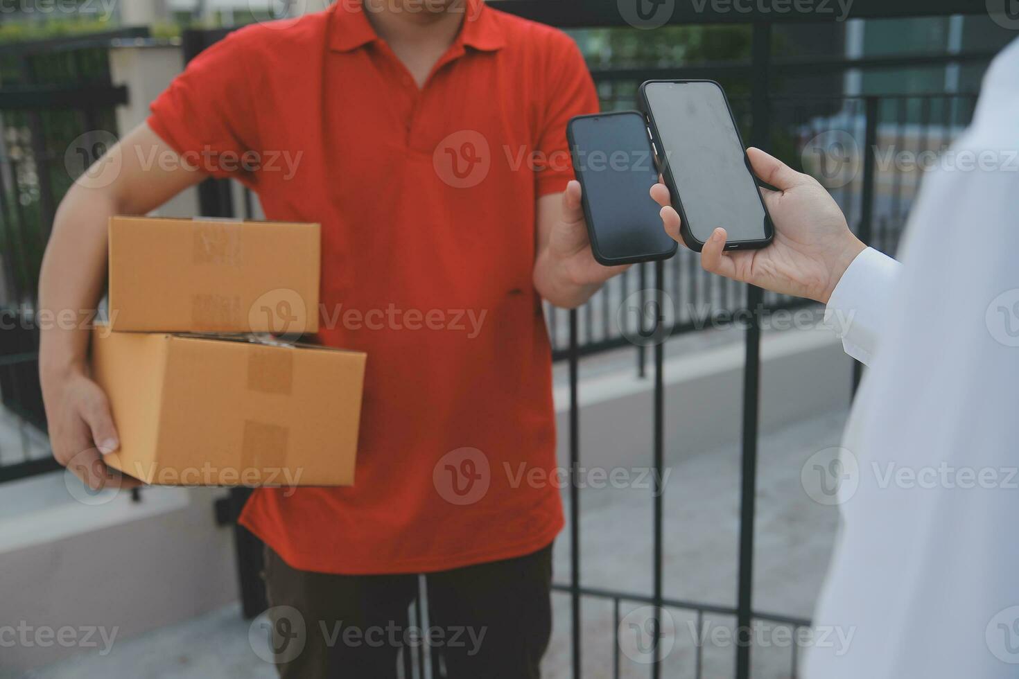 Asian Woman Receiving Product from delivery man at Home, Young Owner Woman Order Product from Smartphone Application, Woman with Online Business or SME Concept. photo