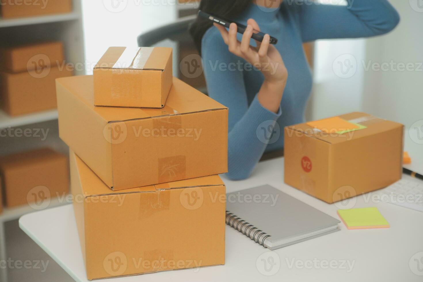 Business woman start up small business entrepreneur SME success .freelance woman working at home with Online Parcel delivery. SME and packaging deliveryconcept photo