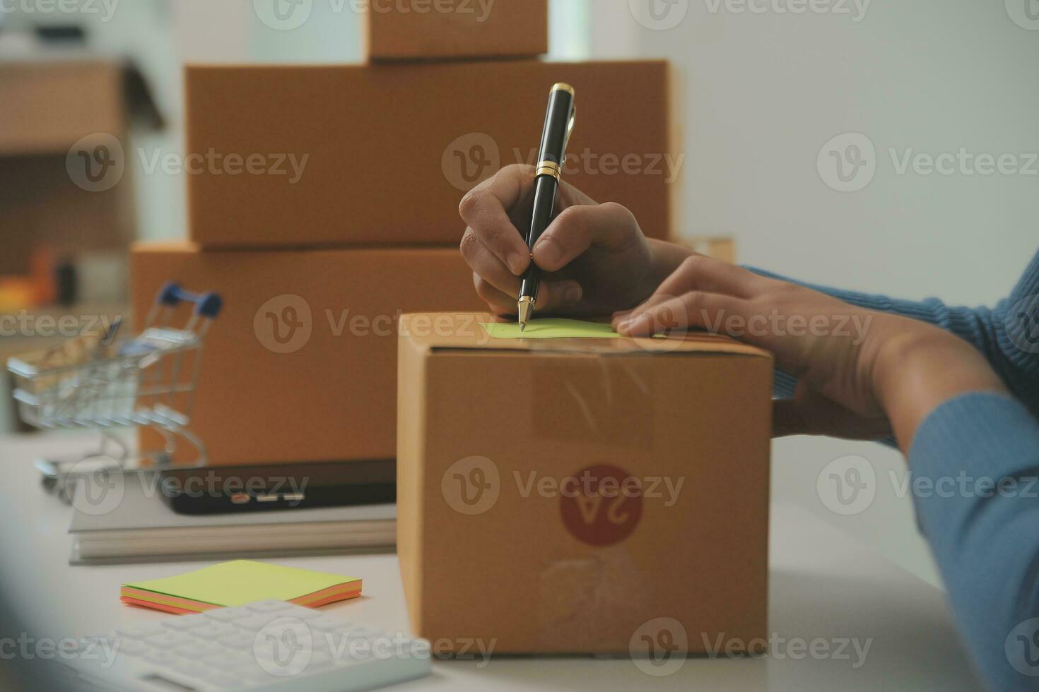 Business woman start up small business entrepreneur SME success .freelance woman working at home with Online Parcel delivery. SME and packaging deliveryconcept photo