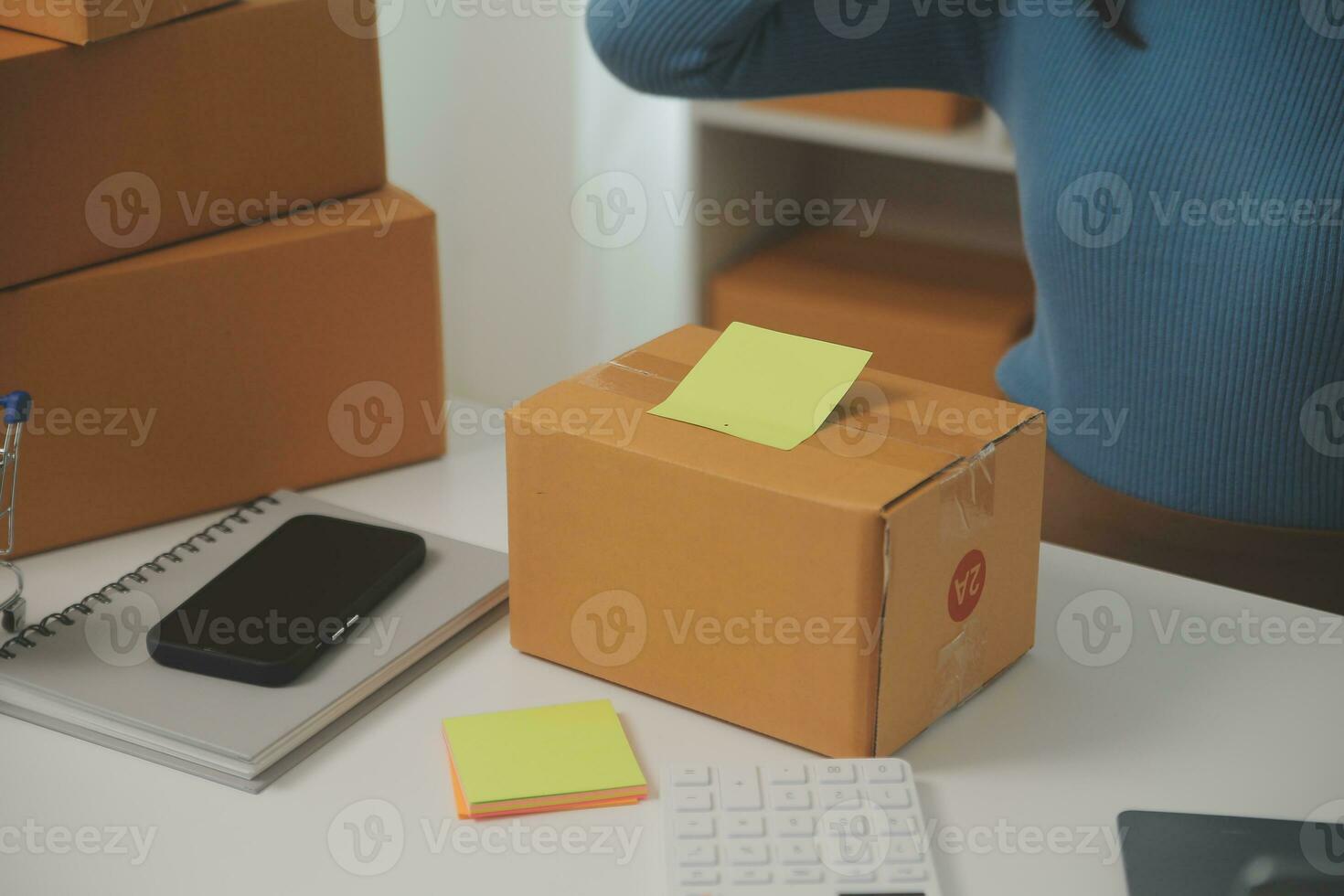 Business woman start up small business entrepreneur SME success .freelance woman working at home with Online Parcel delivery. SME and packaging deliveryconcept photo