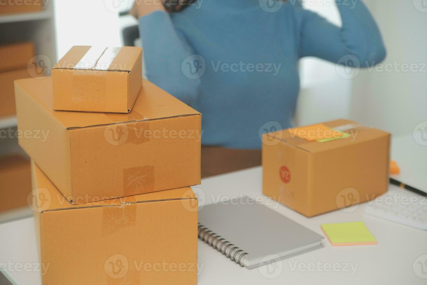 Business woman start up small business entrepreneur SME success .freelance woman working at home with Online Parcel delivery. SME and packaging deliveryconcept photo