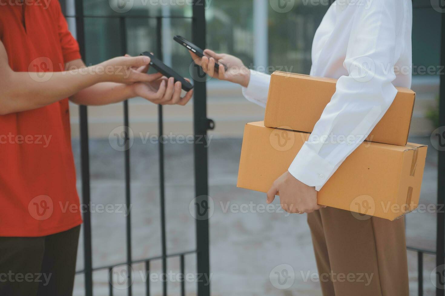 Asian Woman Receiving Product from delivery man at Home, Young Owner Woman Order Product from Smartphone Application, Woman with Online Business or SME Concept. photo