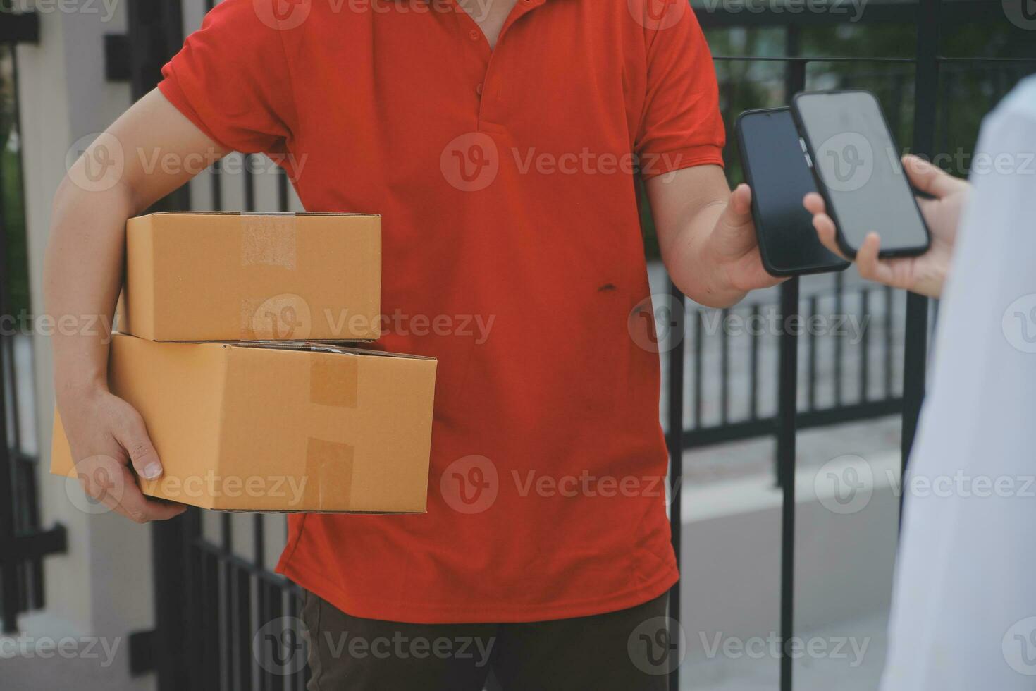 Asian Woman Receiving Product from delivery man at Home, Young Owner Woman Order Product from Smartphone Application, Woman with Online Business or SME Concept. photo