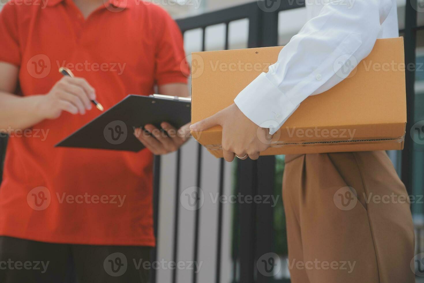 Asian Woman Receiving Product from delivery man at Home, Young Owner Woman Order Product from Smartphone Application, Woman with Online Business or SME Concept. photo