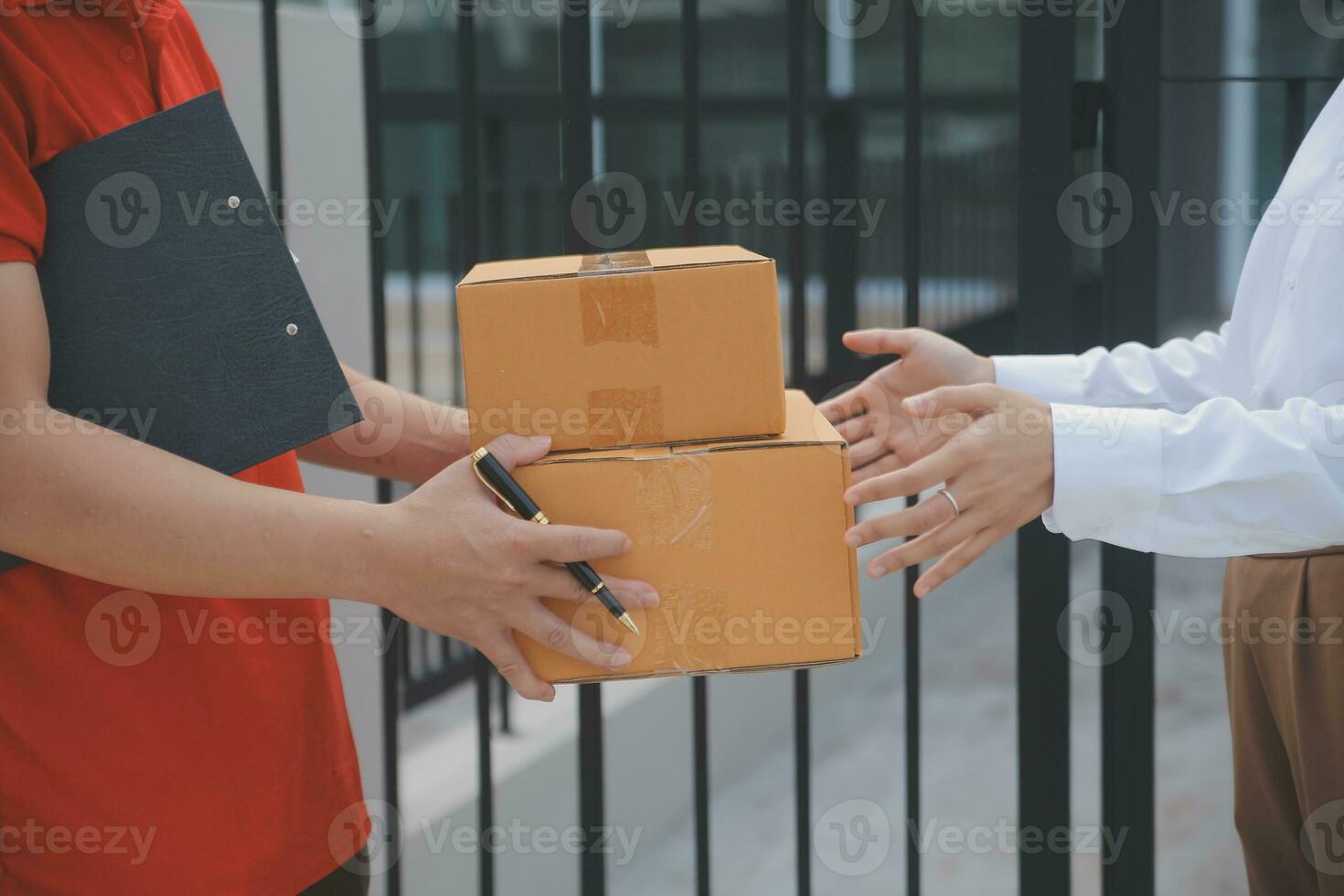 Asian Woman Receiving Product from delivery man at Home, Young Owner Woman Order Product from Smartphone Application, Woman with Online Business or SME Concept. photo