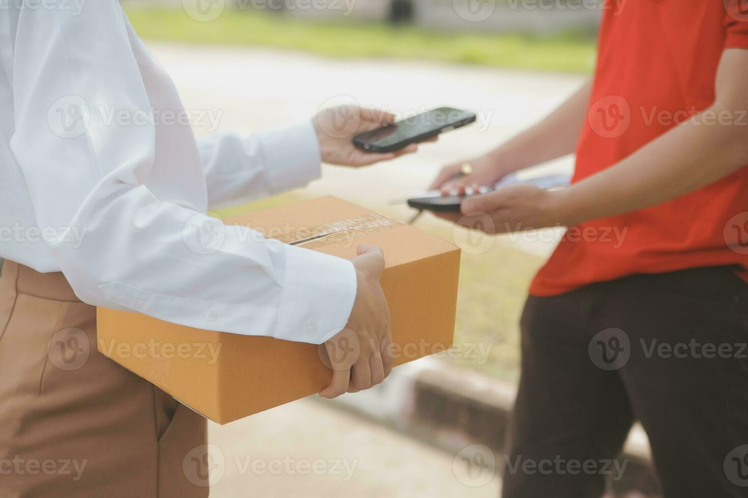 Asian Woman Receiving Product from delivery man at Home, Young Owner Woman Order Product from Smartphone Application, Woman with Online Business or SME Concept. photo