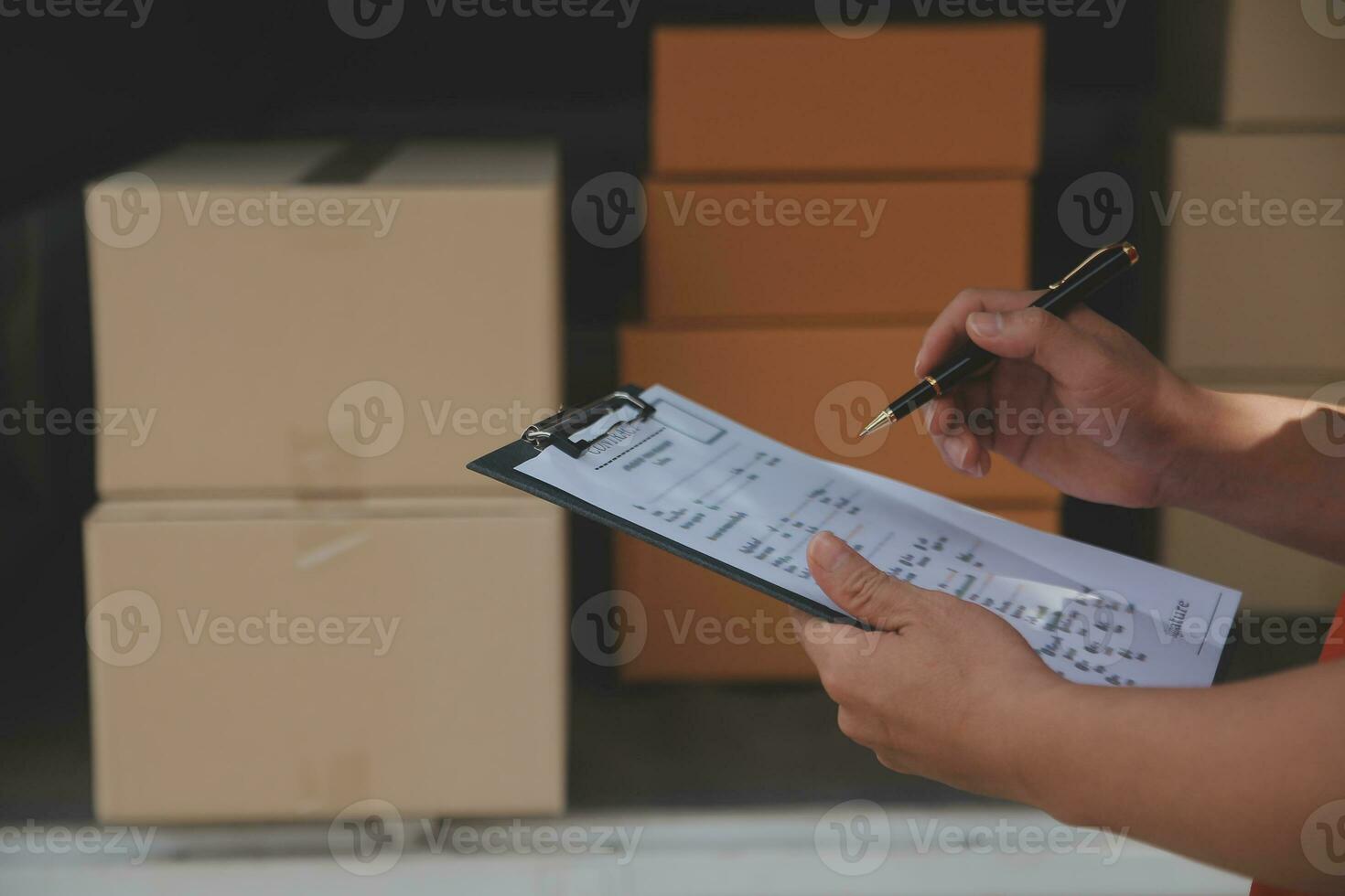 Asian Woman Receiving Product from delivery man at Home, Young Owner Woman Order Product from Smartphone Application, Woman with Online Business or SME Concept. photo