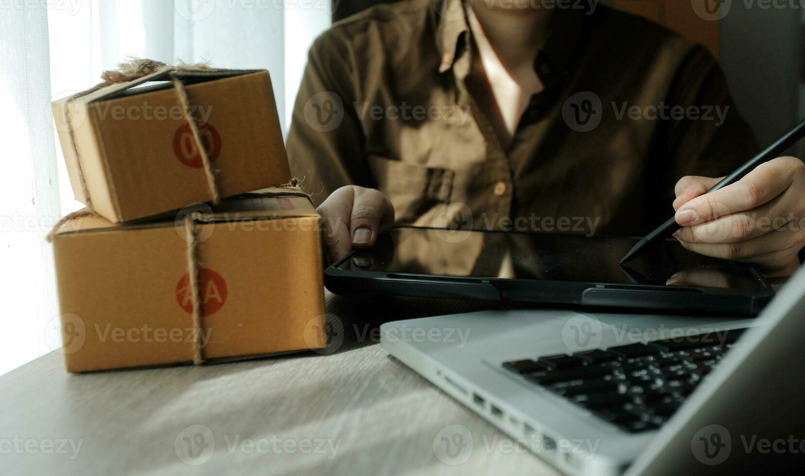Business woman start up small business entrepreneur SME success .freelance woman working at home with Online Parcel delivery. SME and packaging deliveryconcept photo