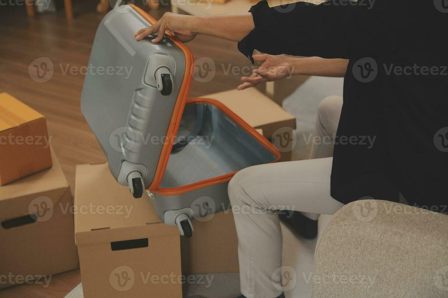 Beautiful young couple in love having fun unpacking things from cardboard boxes while moving in together in their new apartment photo