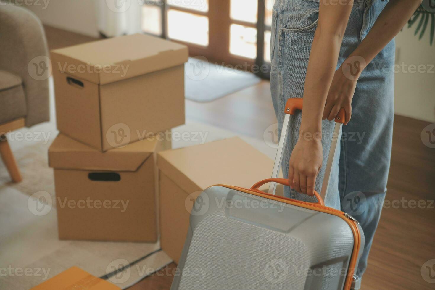 Beautiful young couple in love having fun unpacking things from cardboard boxes while moving in together in their new apartment photo