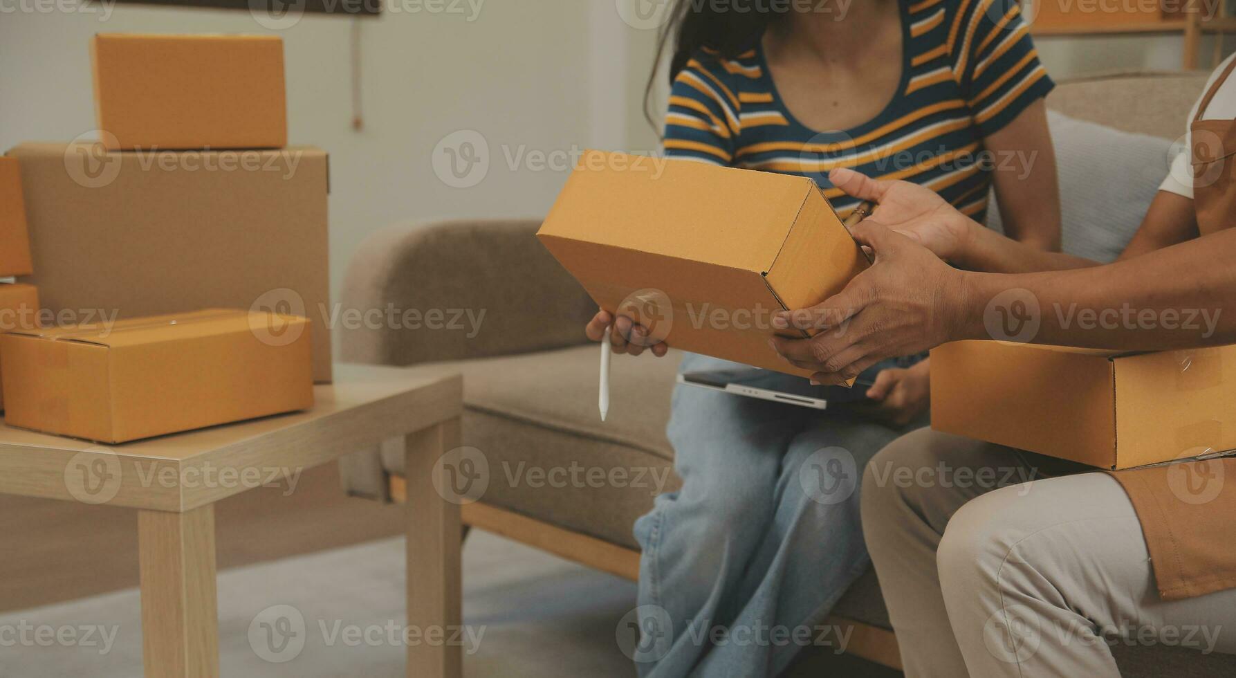 Startup small business owner working with computer at workplace. Freelance two woman seller check product order. Packing goods for delivery to customer. Online selling. E-commerce. Online Shopping photo