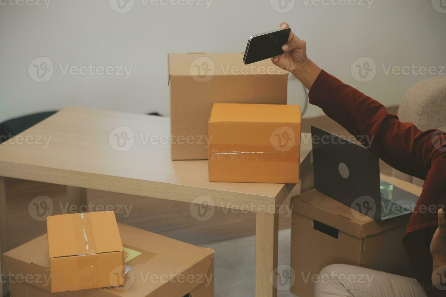 Beautiful young couple in love having fun unpacking things from cardboard boxes while moving in together in their new apartment photo