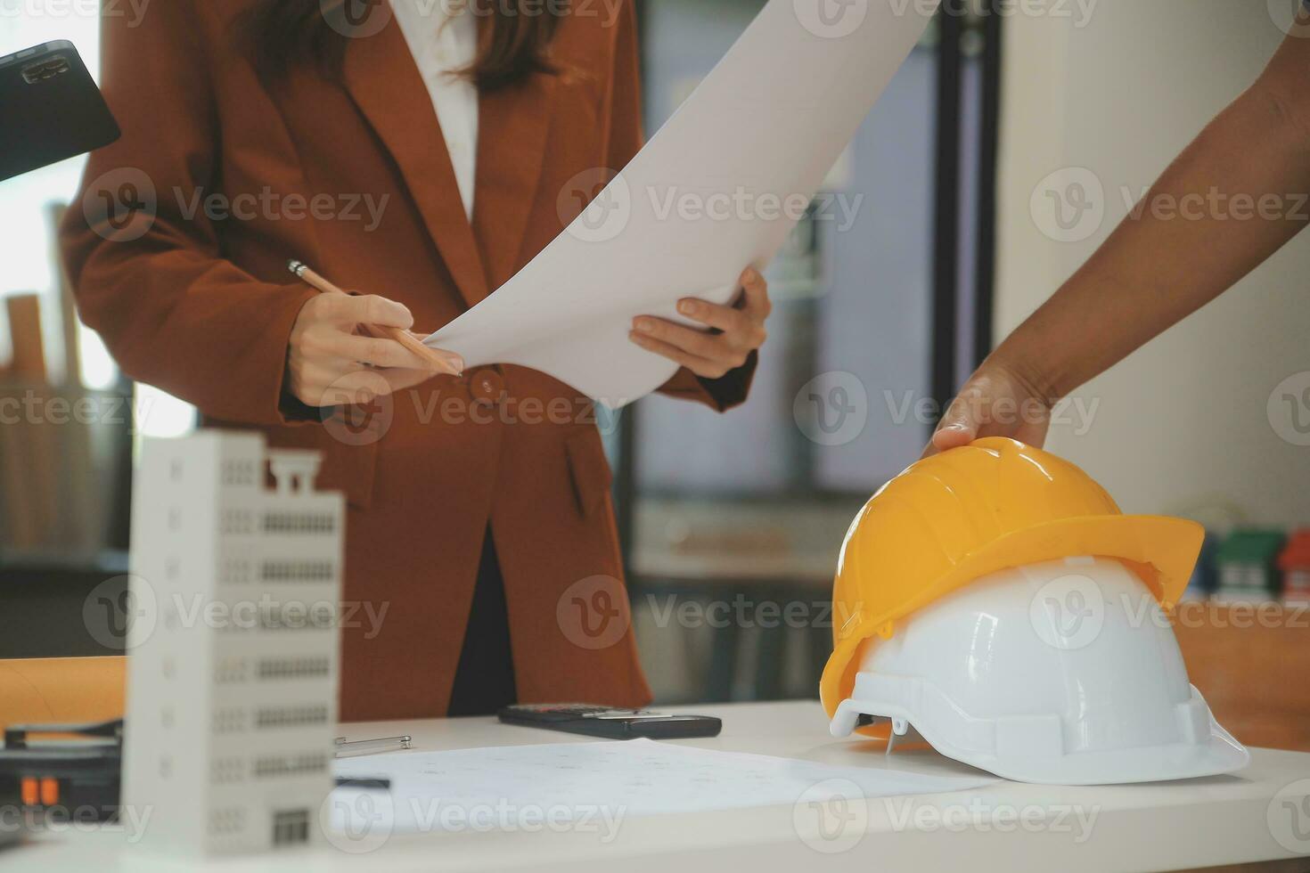 Engineer Teamwork Meeting, Drawing working on blueprint meeting for project working with partner on model building and engineering tools in working site, Construction and structure concept. photo