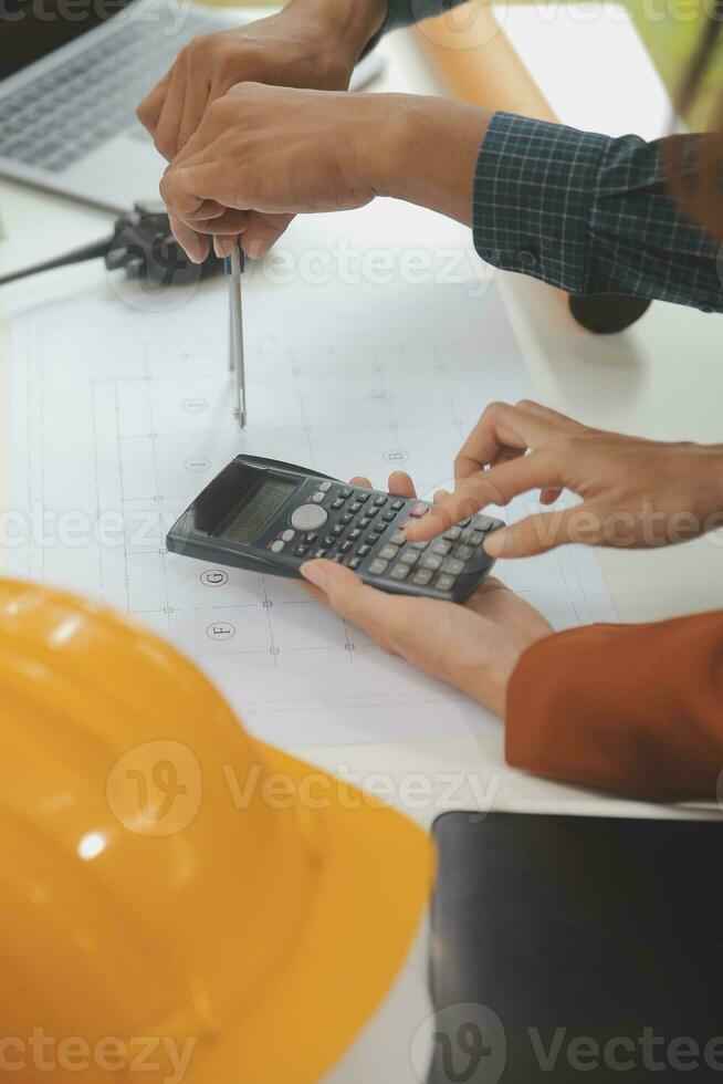 Engineer Teamwork Meeting, Drawing working on blueprint meeting for project working with partner on model building and engineering tools in working site, Construction and structure concept. photo
