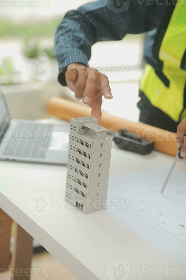 Engineer Teamwork Meeting, Drawing working on blueprint meeting for project working with partner on model building and engineering tools in working site, Construction and structure concept. photo