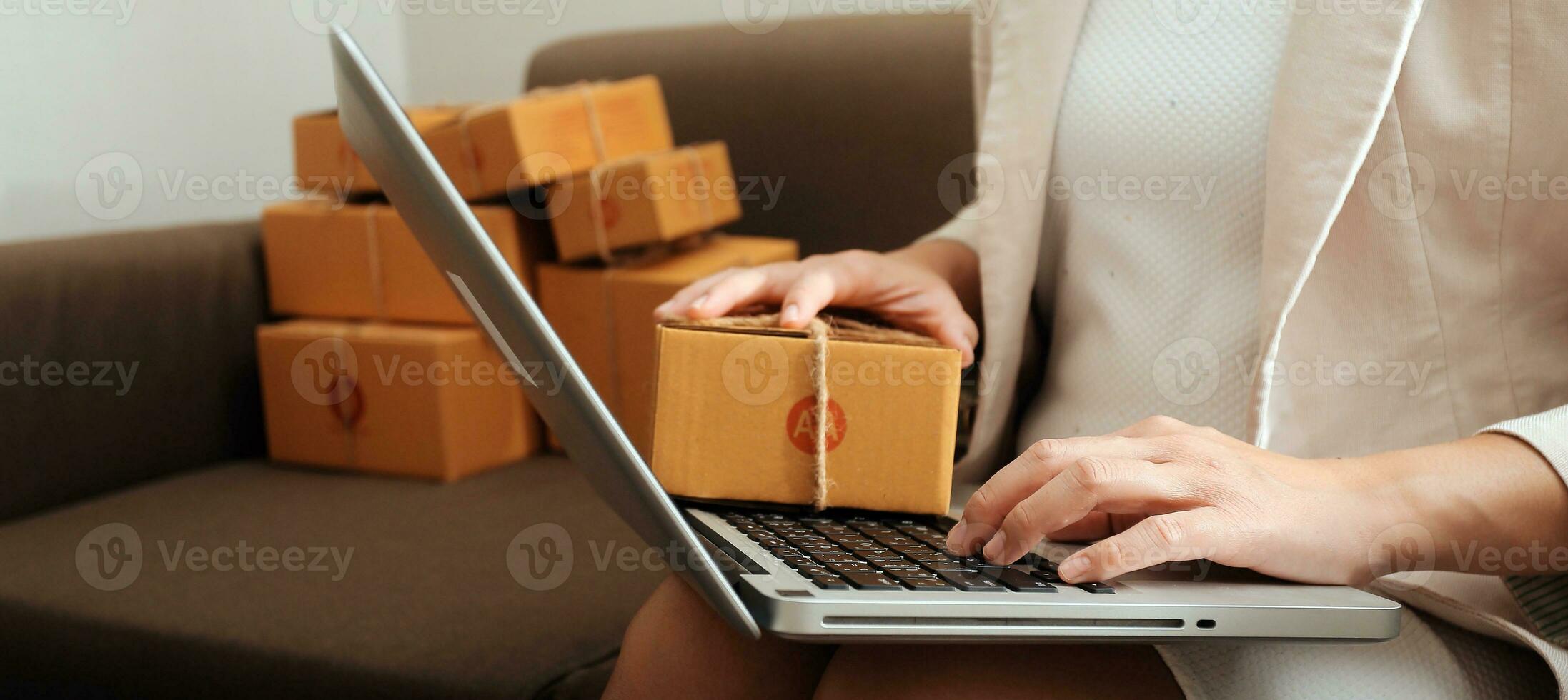 Business woman start up small business entrepreneur SME success .freelance woman working at home with Online Parcel delivery. SME and packaging deliveryconcept photo