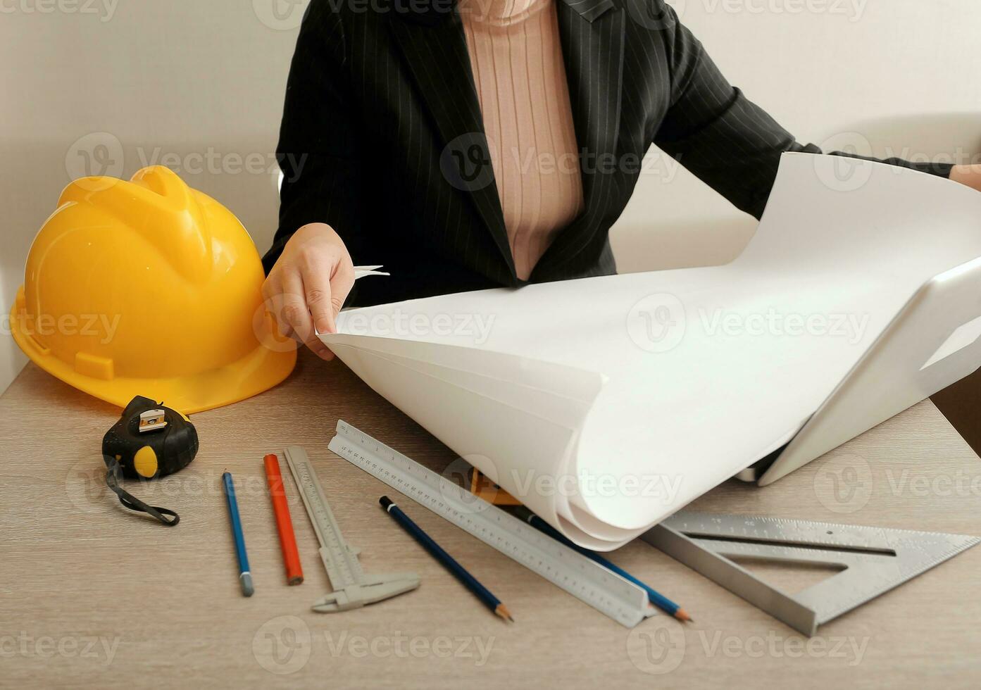 asian woman architect in shirt looking on internet online blueprint document project of green building. female interior designer worker working desktop computer monitor typing keyboard photo
