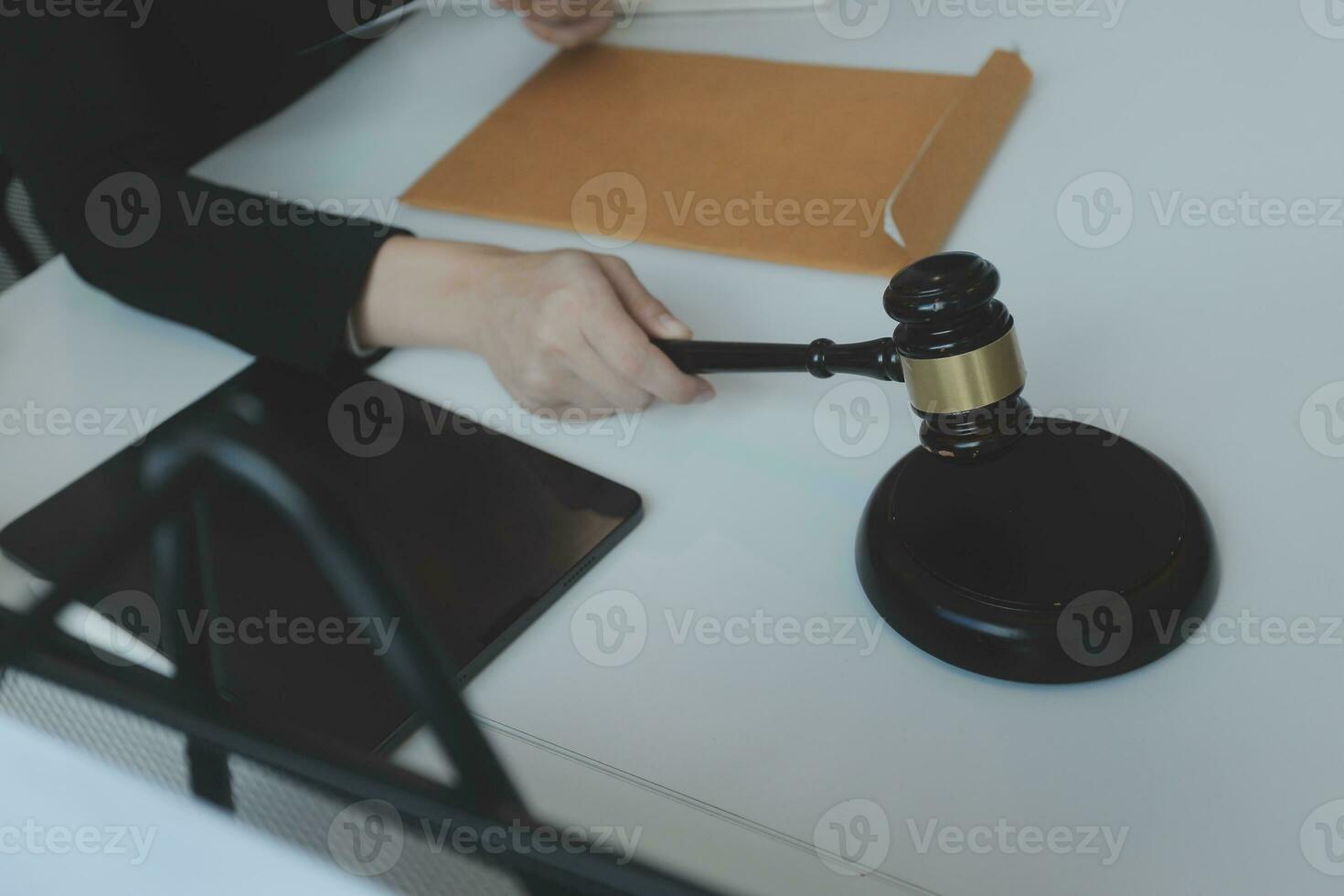 Male lawyer working with contract papers and wooden gavel on tabel in courtroom. justice and law ,attorney, court judge, concept. photo