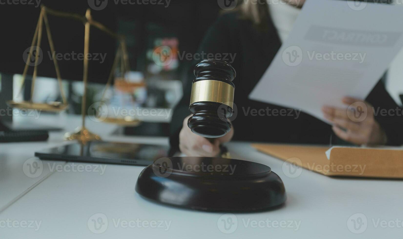 Male lawyer working with contract papers and wooden gavel on tabel in courtroom. justice and law ,attorney, court judge, concept. photo