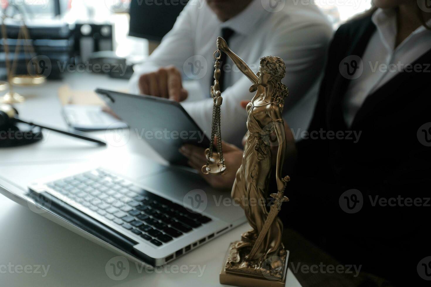 Justice and Law concept. Legal counsel presents to the client a signed contract with gavel and legal law or legal having team meeting at law firm in background photo