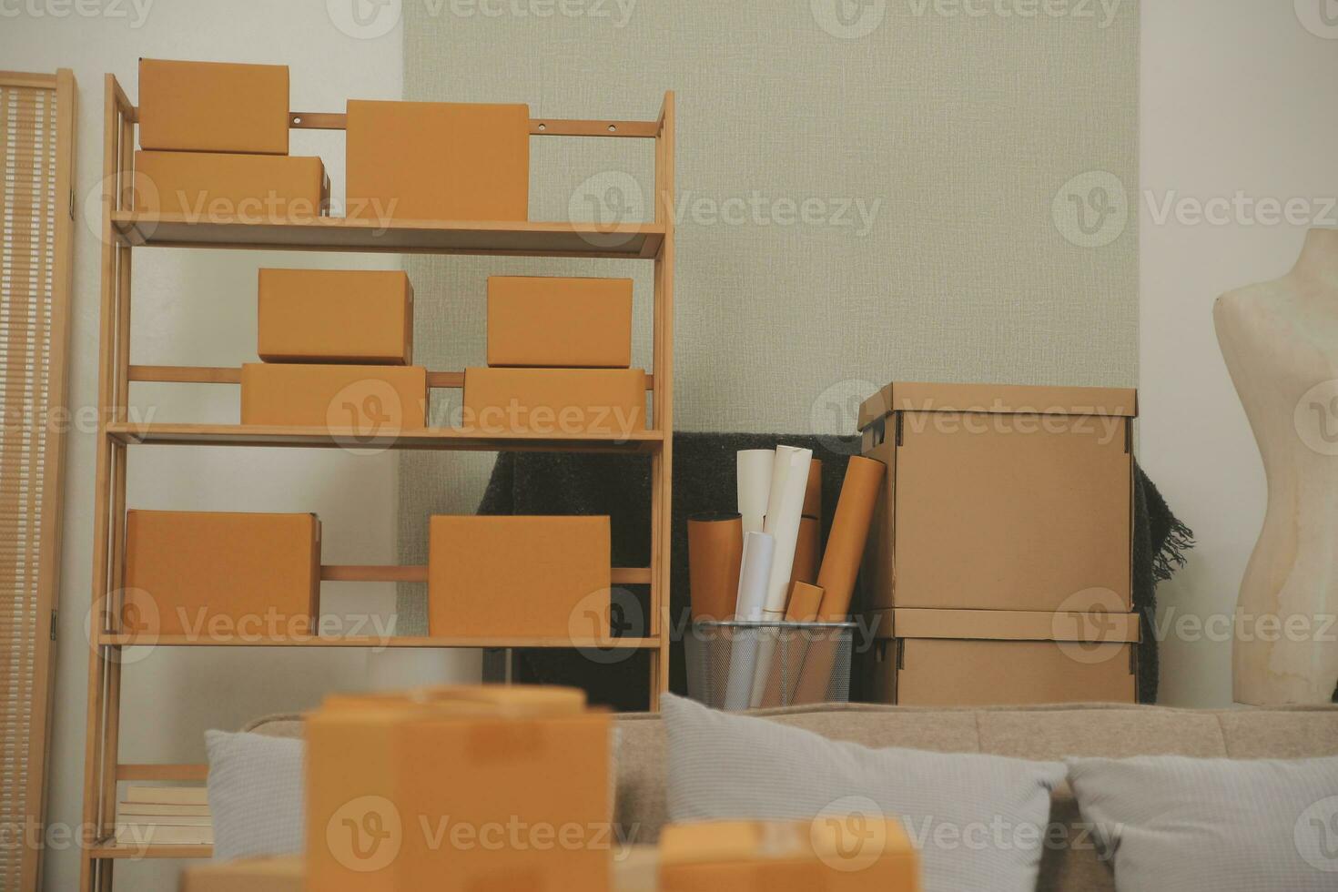 Beautiful young couple in love having fun unpacking things from cardboard boxes while moving in together in their new apartment photo