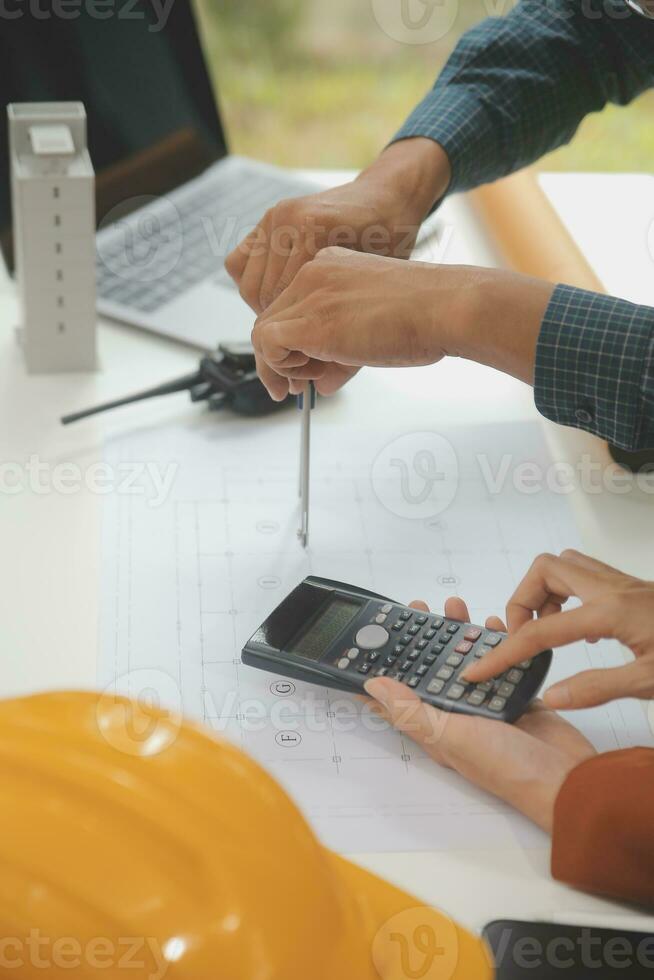 Engineer Teamwork Meeting, Drawing working on blueprint meeting for project working with partner on model building and engineering tools in working site, Construction and structure concept. photo