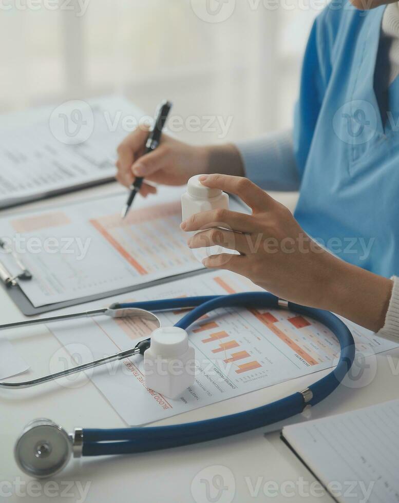 Stethoscope and background doctor using laptop at desk in clinic working on computer at room office. photo