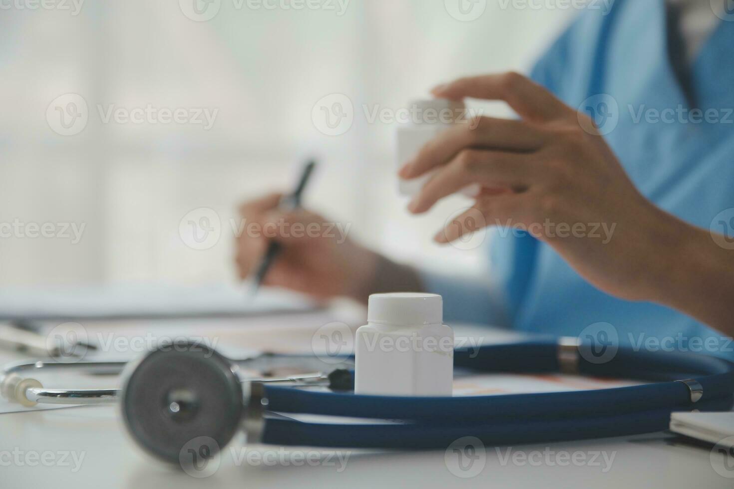 Stethoscope and background doctor using laptop at desk in clinic working on computer at room office. photo