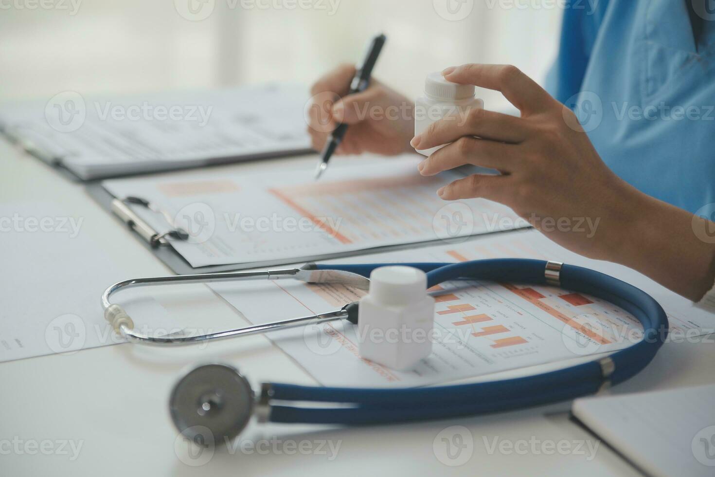 Stethoscope and background doctor using laptop at desk in clinic working on computer at room office. photo