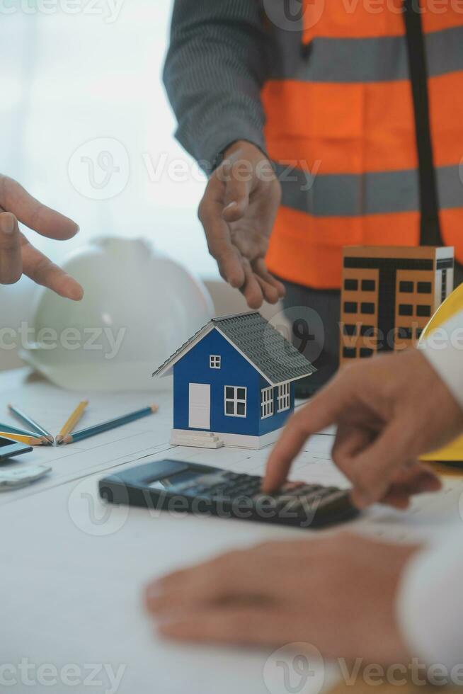 Construction and structure concept of Engineer or architect meeting for project working with partner and engineering tools on model building and blueprint in working site, contract for both companies. photo