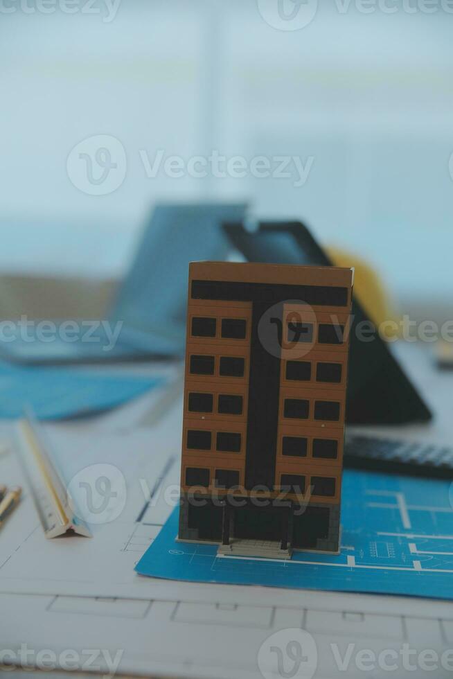 Construction and structure concept of Engineer or architect meeting for project working with partner and engineering tools on model building and blueprint in working site, contract for both companies. photo