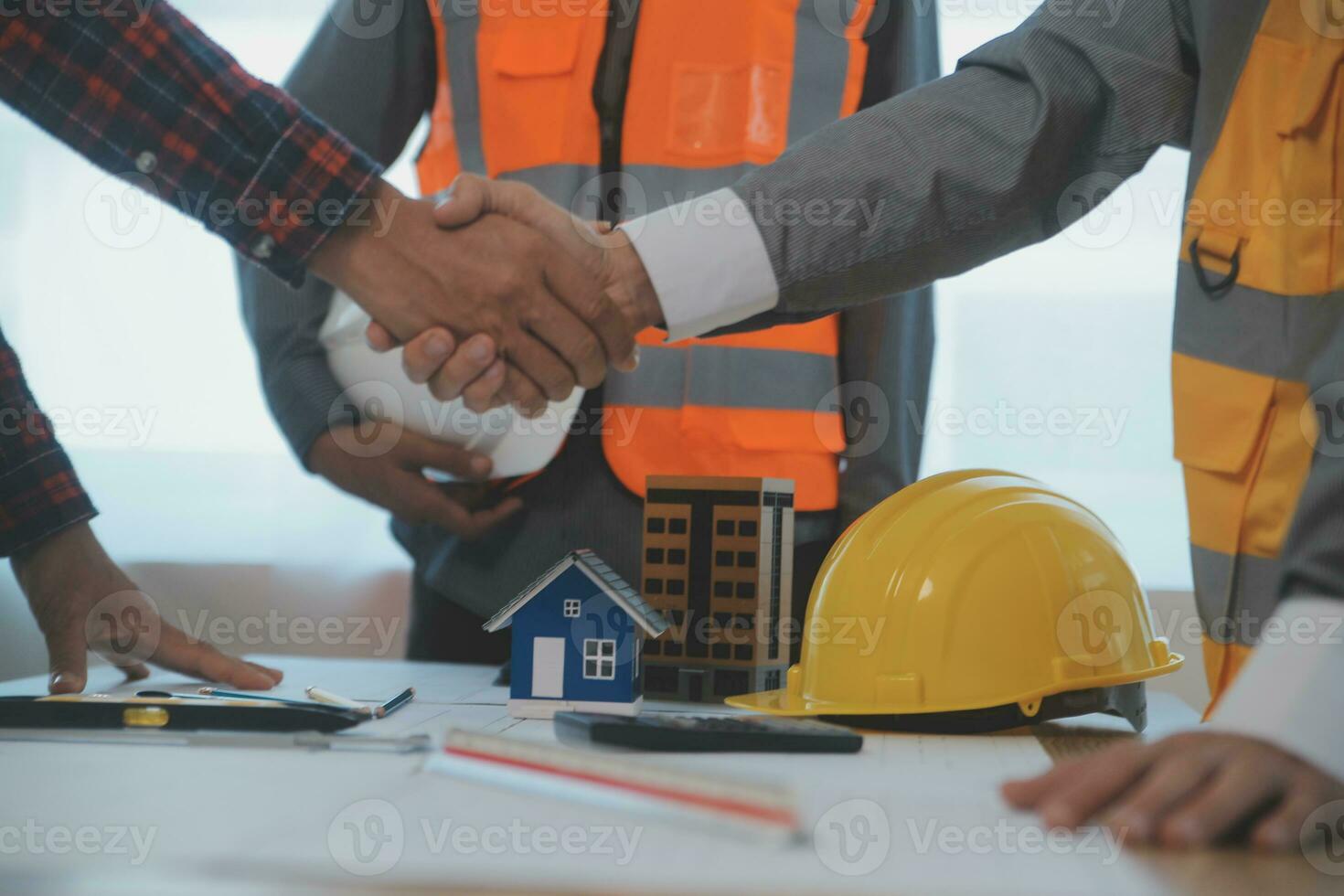 Construction and structure concept of Engineer or architect meeting for project working with partner and engineering tools on model building and blueprint in working site, contract for both companies. photo