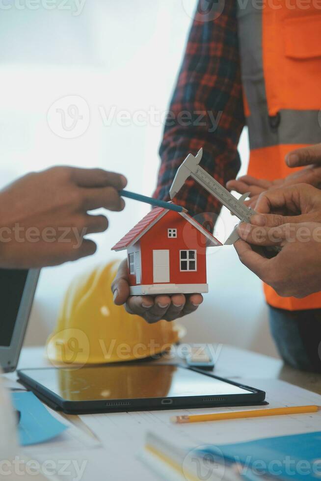 Construction and structure concept of Engineer or architect meeting for project working with partner and engineering tools on model building and blueprint in working site, contract for both companies. photo