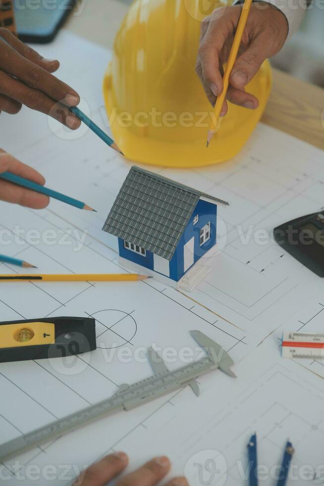 Construction and structure concept of Engineer or architect meeting for project working with partner and engineering tools on model building and blueprint in working site, contract for both companies. photo