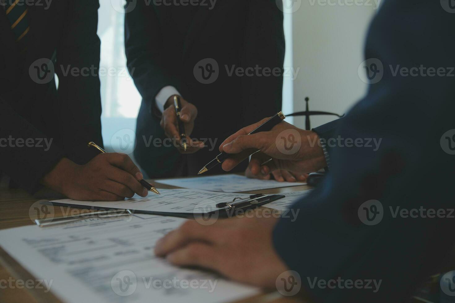 Consultation and conference of Male lawyers and professional businesswoman working and discussion having at law firm in office. Concepts of law, Judge gavel with scales of justice. photo