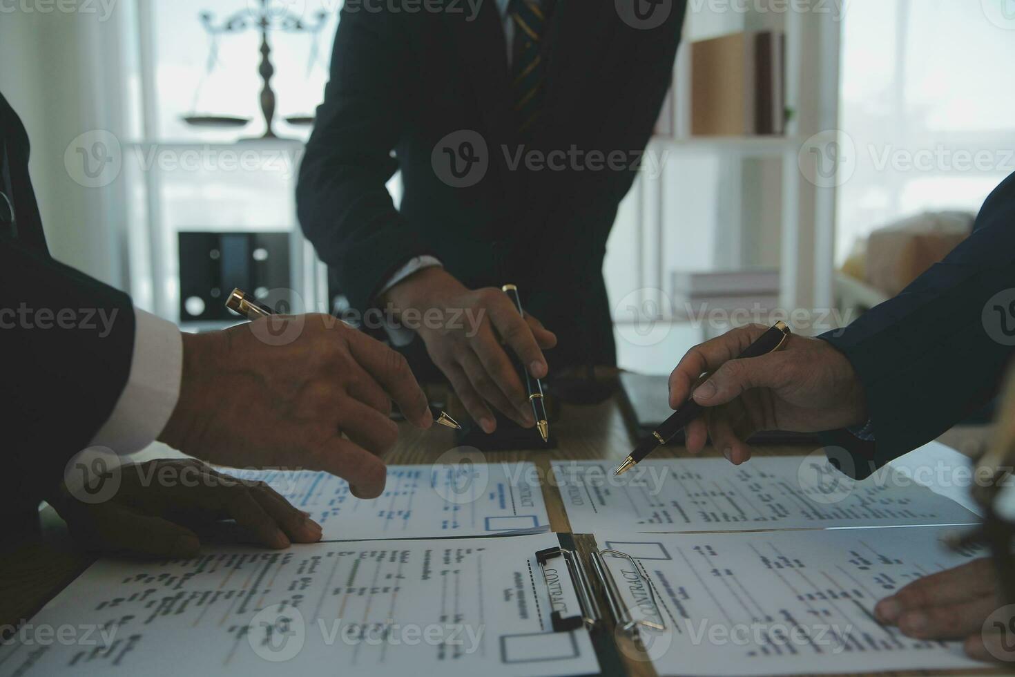 Consultation and conference of Male lawyers and professional businesswoman working and discussion having at law firm in office. Concepts of law, Judge gavel with scales of justice. photo
