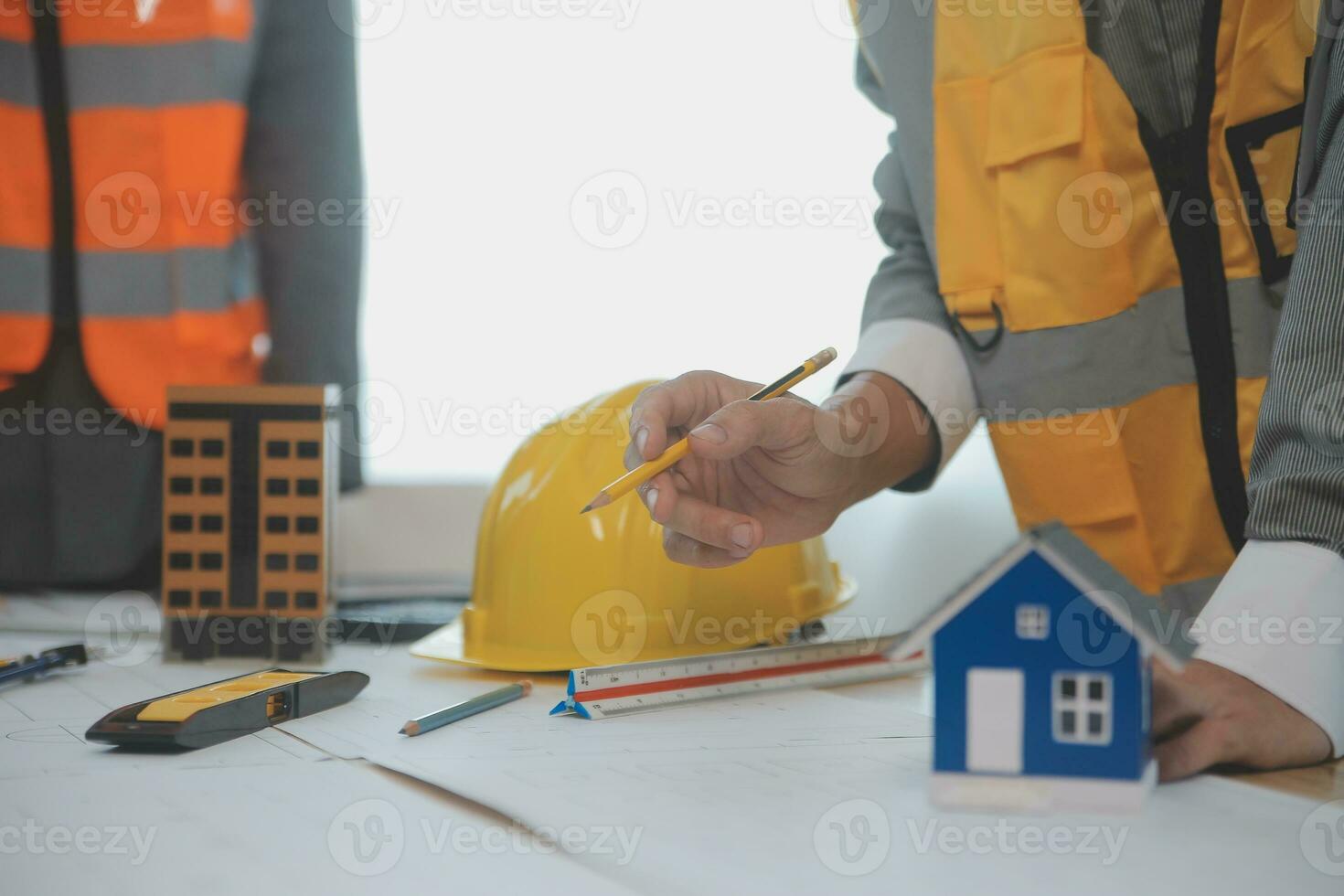 Construction and structure concept of Engineer or architect meeting for project working with partner and engineering tools on model building and blueprint in working site, contract for both companies. photo
