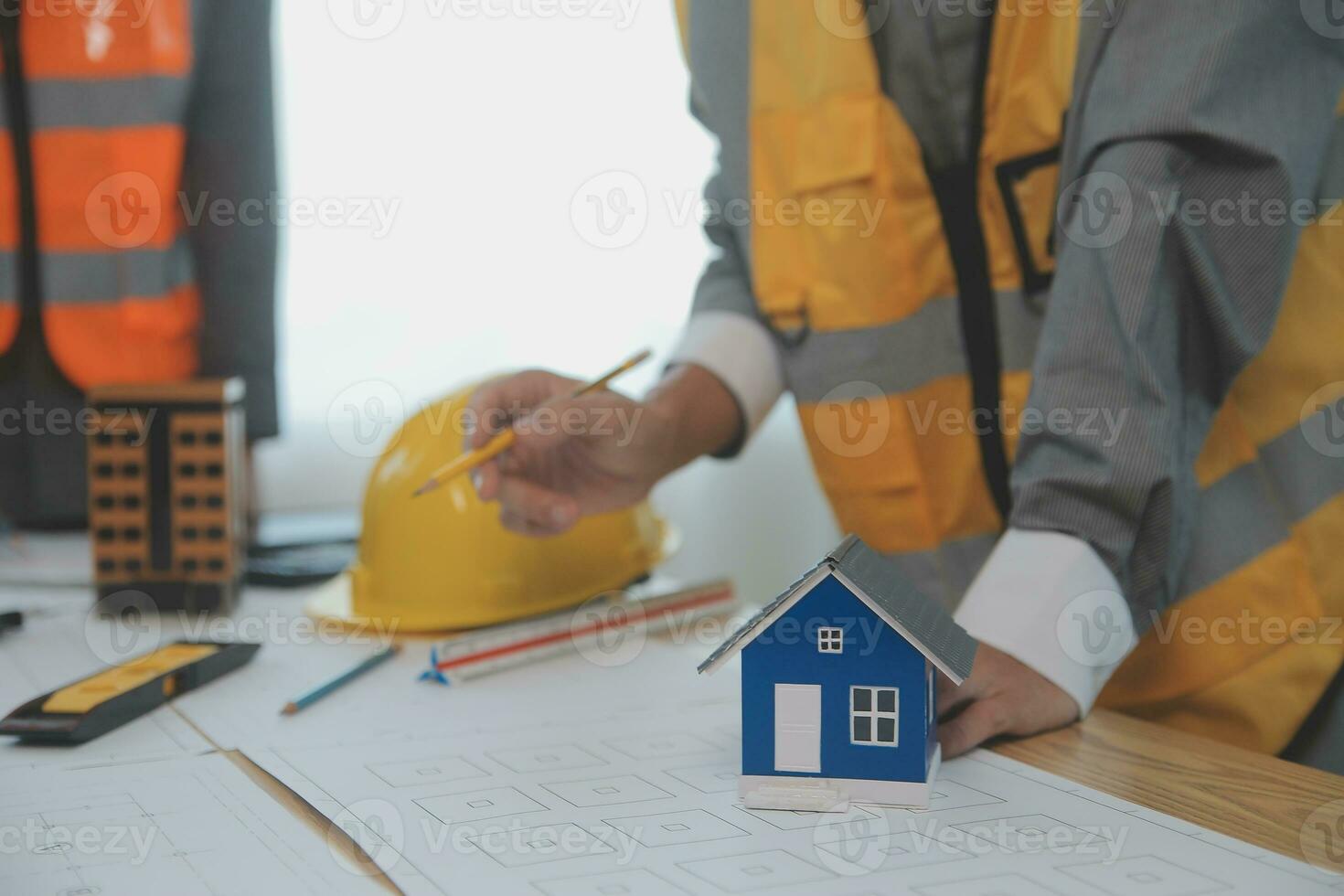 Construction and structure concept of Engineer or architect meeting for project working with partner and engineering tools on model building and blueprint in working site, contract for both companies. photo