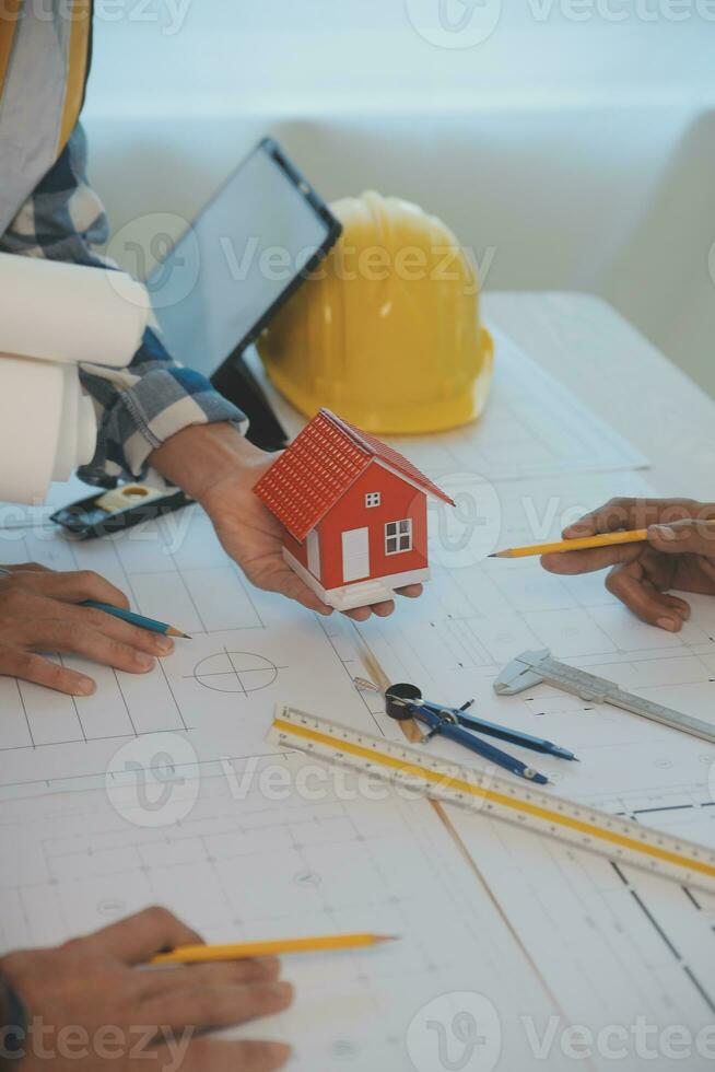 Construction and structure concept of Engineer or architect meeting for project working with partner and engineering tools on model building and blueprint in working site, contract for both companies. photo