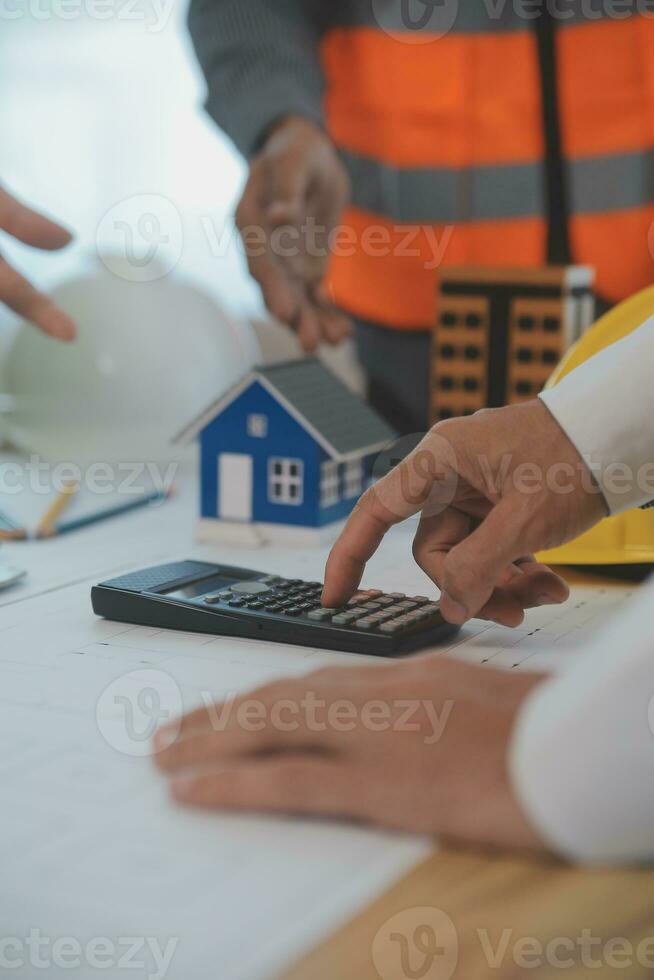Construction and structure concept of Engineer or architect meeting for project working with partner and engineering tools on model building and blueprint in working site, contract for both companies. photo