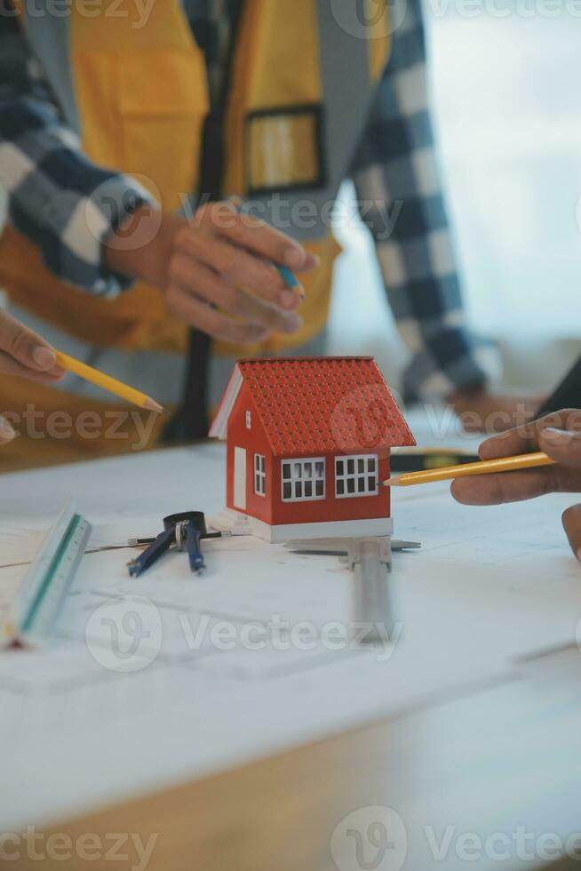 Construction and structure concept of Engineer or architect meeting for project working with partner and engineering tools on model building and blueprint in working site, contract for both companies. photo
