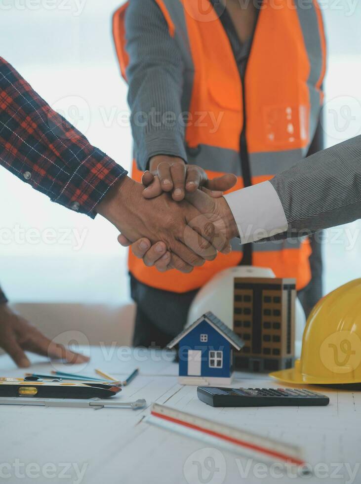 Construction and structure concept of Engineer or architect meeting for project working with partner and engineering tools on model building and blueprint in working site, contract for both companies. photo