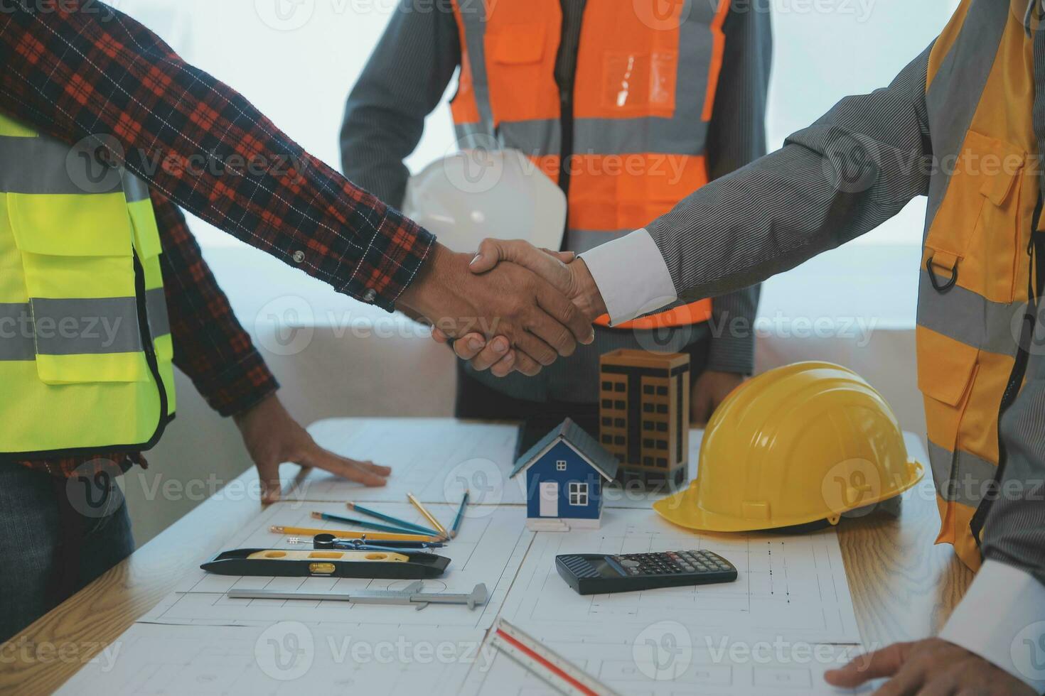 Construction and structure concept of Engineer or architect meeting for project working with partner and engineering tools on model building and blueprint in working site, contract for both companies. photo
