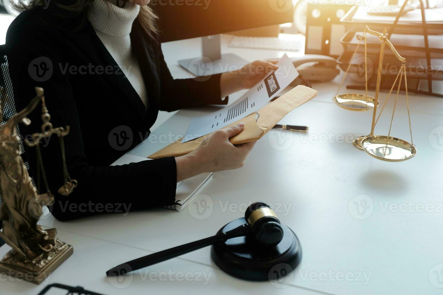 Male lawyer working with contract papers and wooden gavel on tabel in courtroom. justice and law ,attorney, court judge, concept. photo