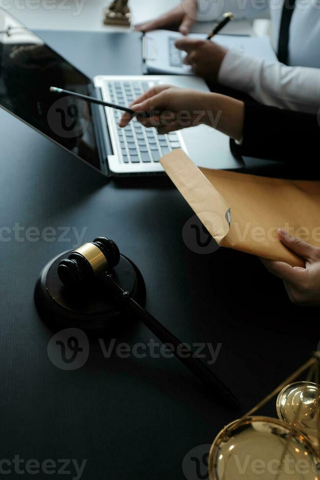 Male lawyer working with contract papers and wooden gavel on tabel in courtroom. justice and law ,attorney, court judge, concept. photo