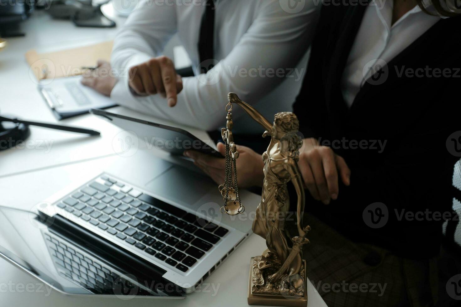 Male lawyer working with contract papers and wooden gavel on tabel in courtroom. justice and law ,attorney, court judge, concept. photo